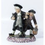 Early 19th century blue tin glaze Staffordshire decorated figure of the drunken Pastor with the