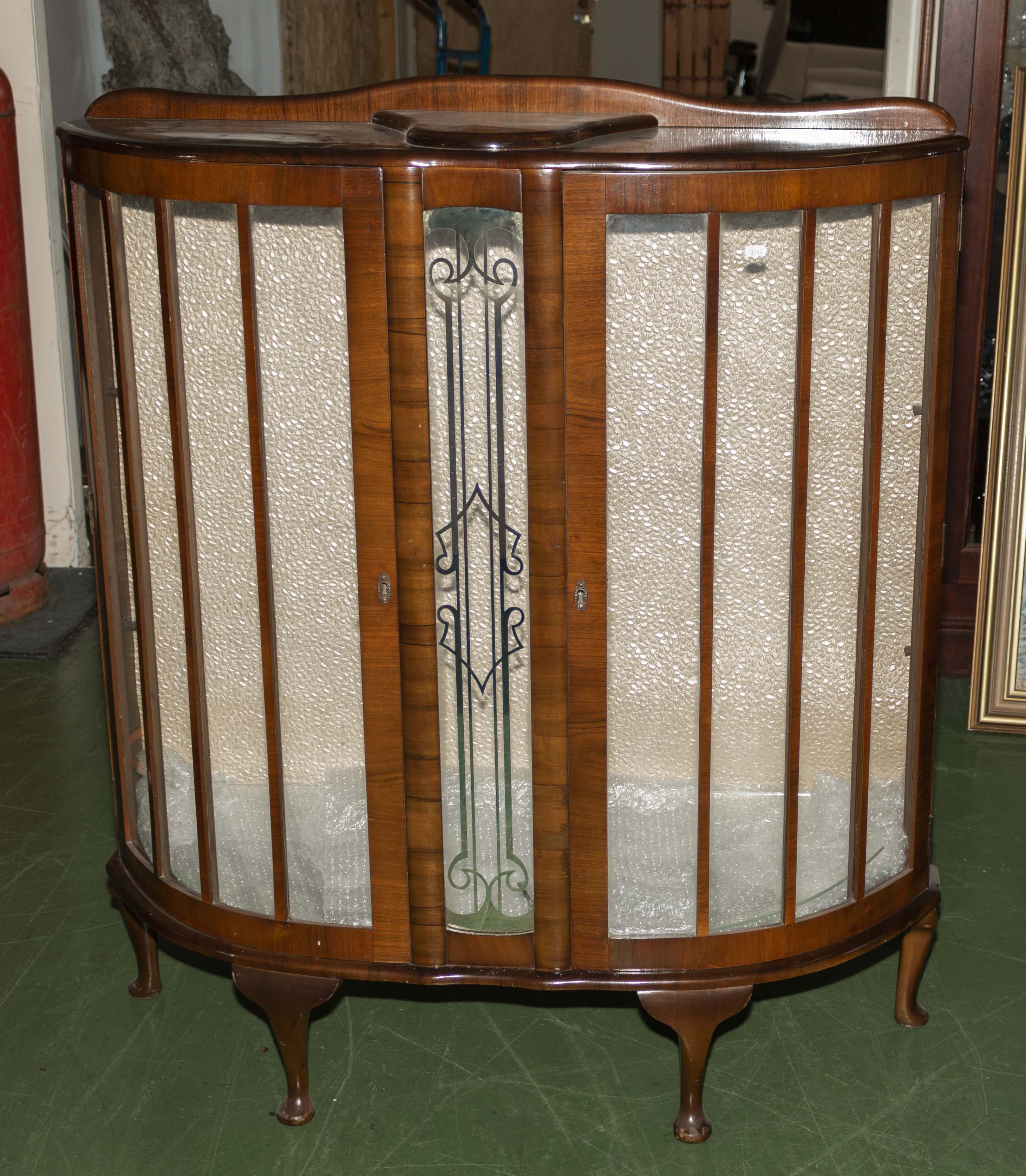 A vintage walnut display cabinet.