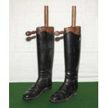 A pair of leather riding boots with trees.