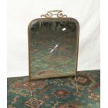 A brass framed fire screen with mirror