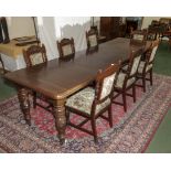 A Victorian oak windout table and 7 chairs.