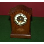 An Edwardian oak mantle clock.
