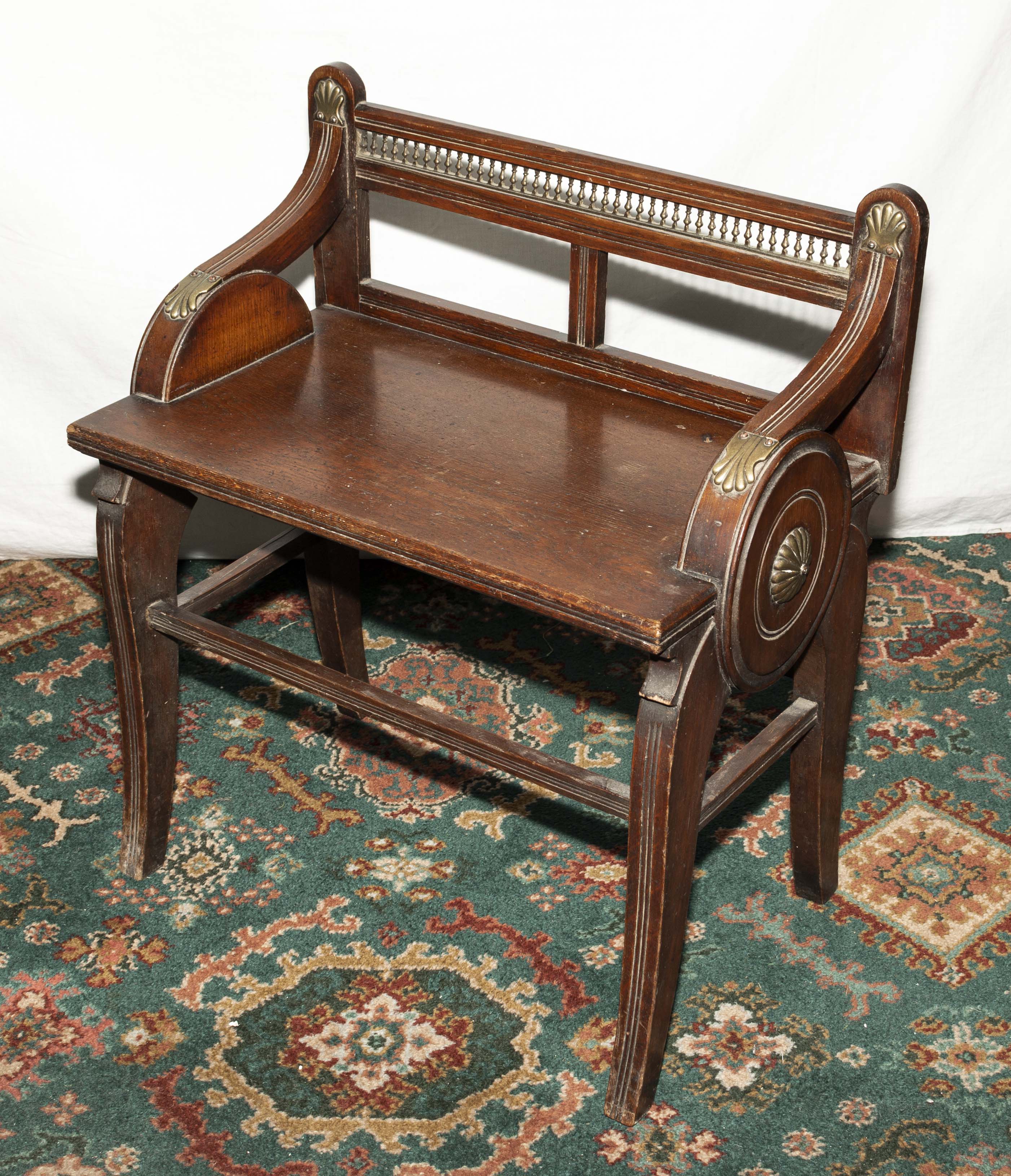 A James Shoolbred and company oak and brass mounted window seat. Lozenger date stamp to seat Trade