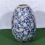 A 20th century Chinese egg shaped vase blue ground with prunus decoration, 32cm tall