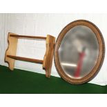 A wall shelf and an oval mirror