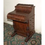 A Victorian walnut piano top davenport desk with pop up top.