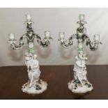 A pair of Dresden style porcelain candelabra, a woman child holding three branch candleabra