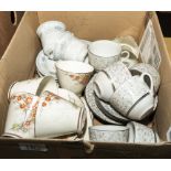 A box containing teacups and saucers