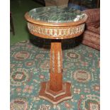 A marble top pedestal with brass mounts