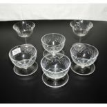 Four glass sundae dishes and two glasses