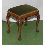 A walnut stool with cabriole legs