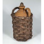 A vintage earthenware wicker bottle