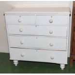 A white painted pine chest of two drawers over three