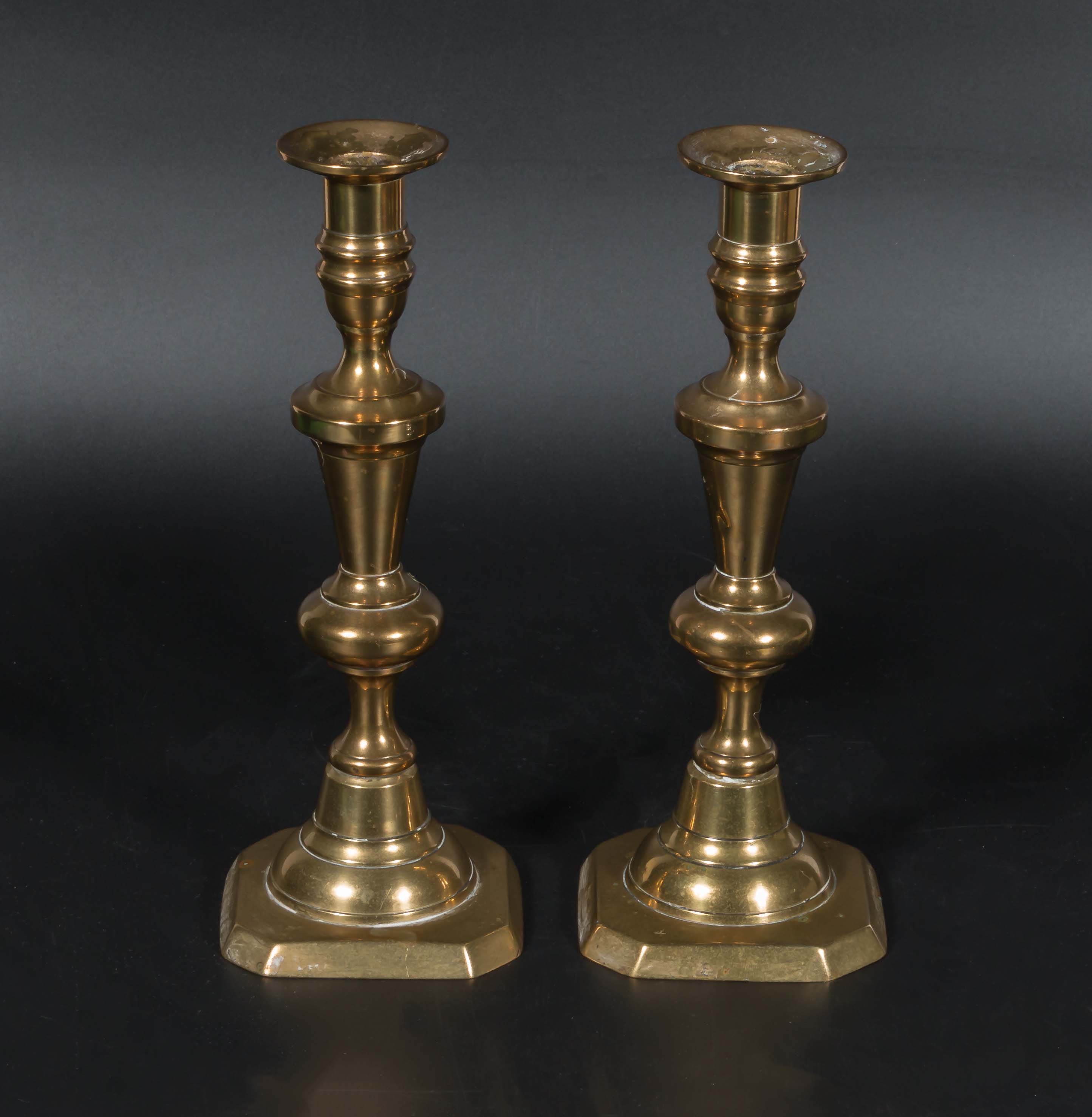 A pair of brass candle sticks