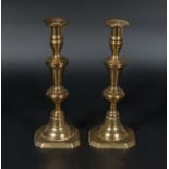 A pair of brass candle sticks