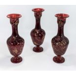 Three ruby glass vases
