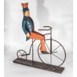 A model of a gentleman riding a penny farthing