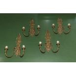 Four brass wall sconces