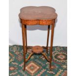 A small satinwood table with painted decoration.