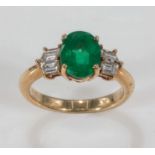 An 18ct gold ring set with baguette diamonds and a emerald, size L