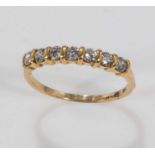 An 18ct gold half eternity ring set with seven diamonds, size N