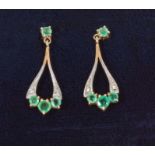 A pair of 9ct gold earrings set with emeralds and diamonds