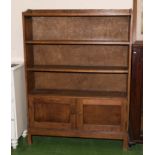 An oak open bookcase on cupboards