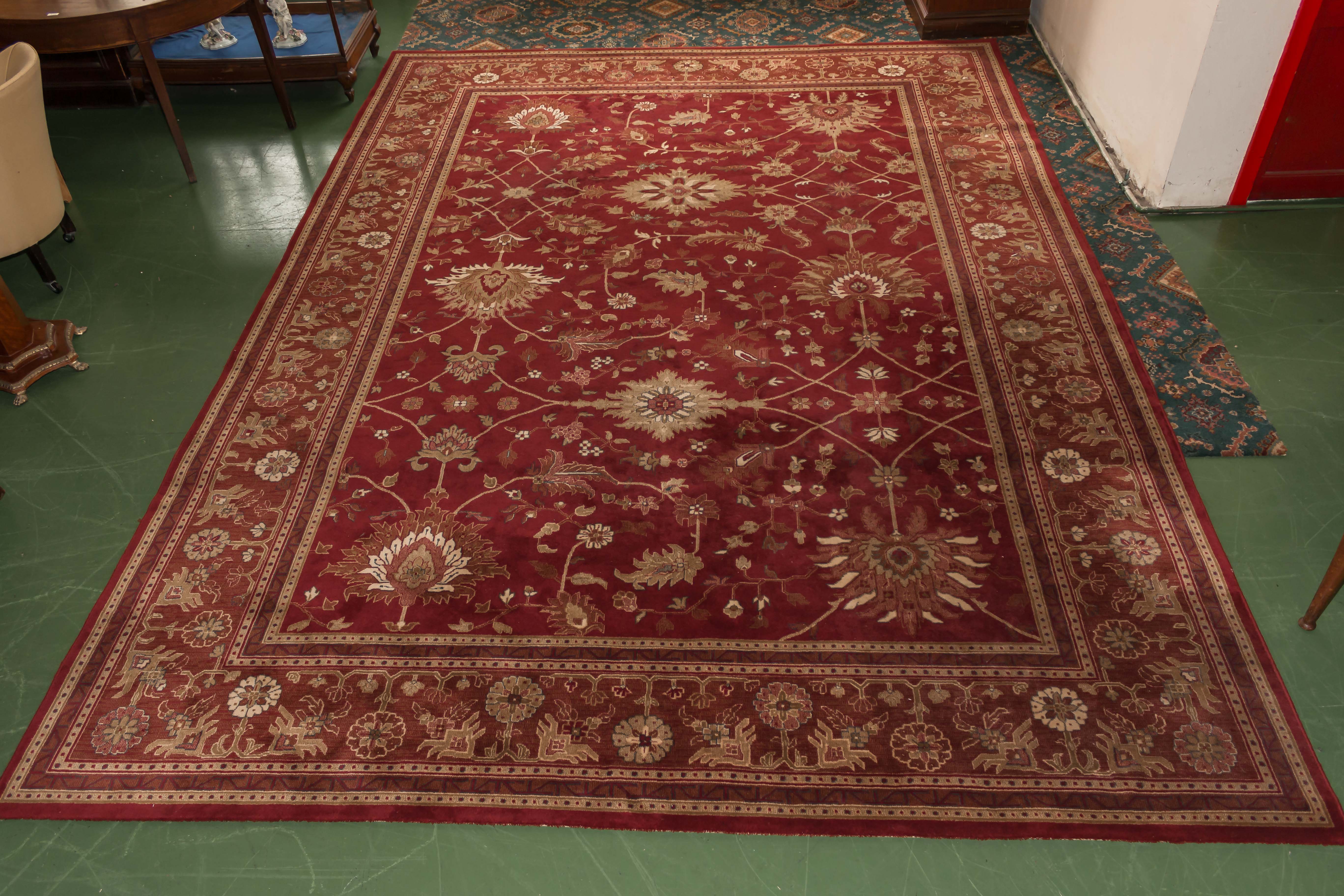 A large red ground wool rug. 3m x 4.2m