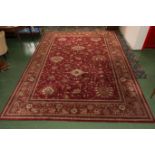A large red ground wool rug. 3m x 4.2m