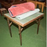 A folding card table and two rugs