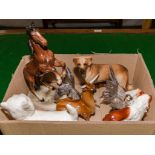 A box containing pottery animals and two metal birds