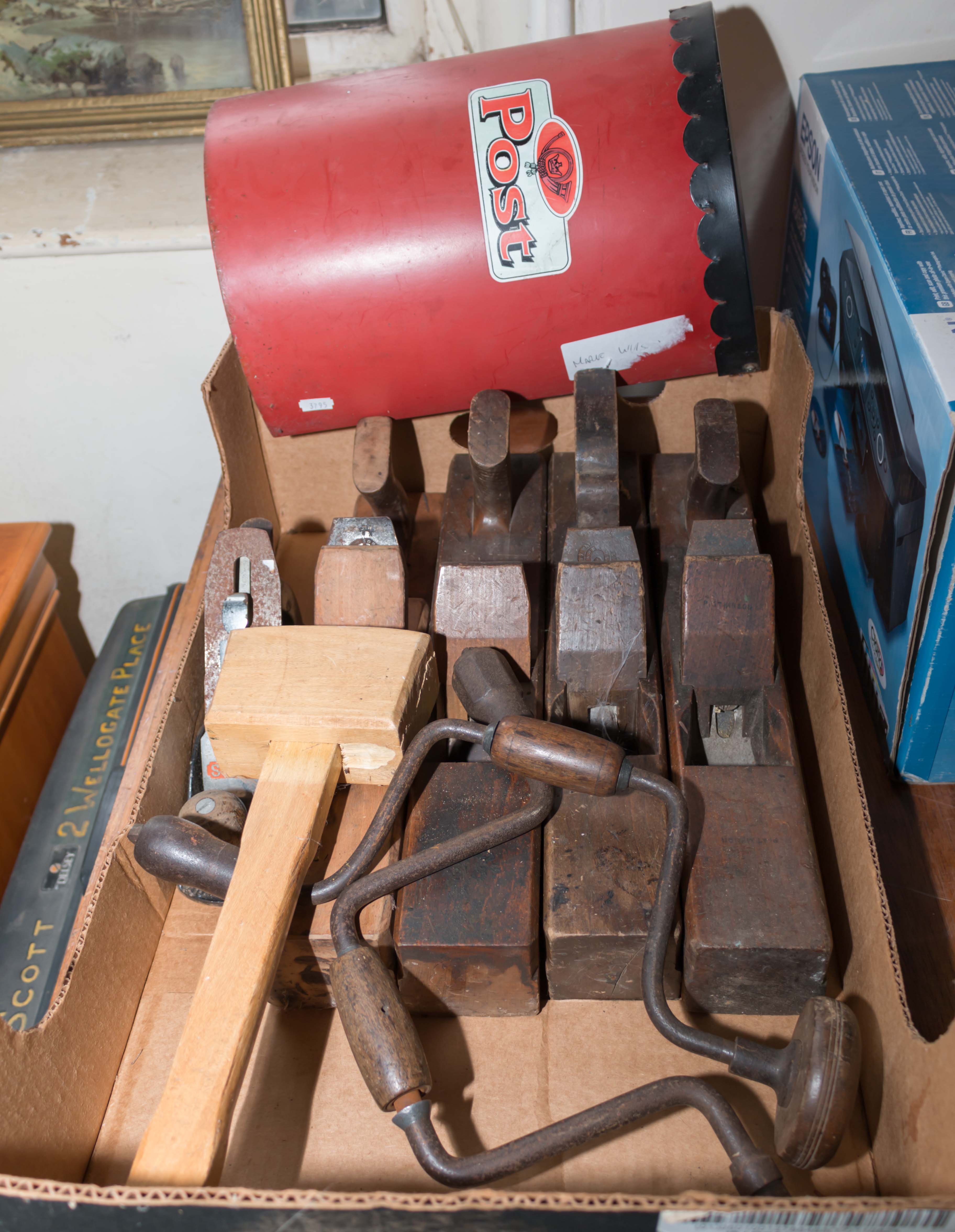 A box containing vintage planes and other tools