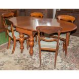 A Victorian mahogany wind out dining table and five chairs.