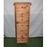 A tall pine chest of drawers