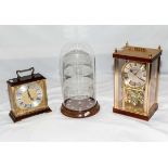 Two clocks and a glass dome display case