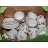 box containing teacups and saucers