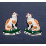 A pair of small Staffordshire style cats