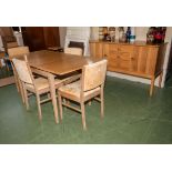 A light oak dining room suite comprising sideboard, table and four chairs