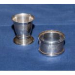 A silver napkin ring and a silver egg cup