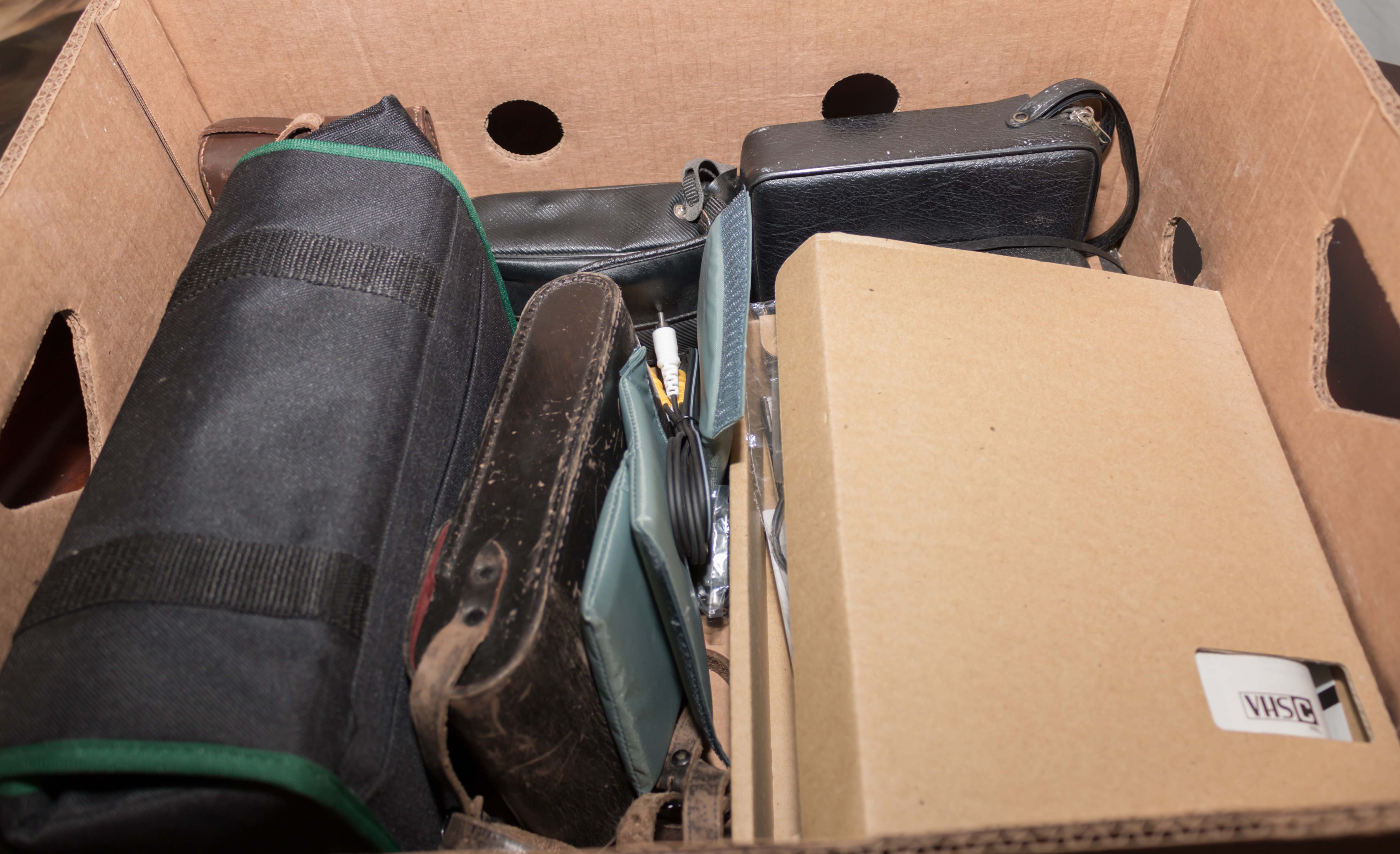 A box containing assorted cameras