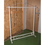 A wrought iron clothes rail