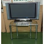 A Hitachi 32" plasma television with stand