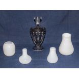 A glass decanter and four white glass vases