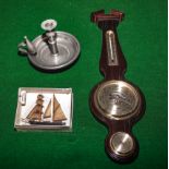 A candlestick, small barometer and small model ship