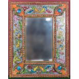 A mirror with decorative hand painted Mexican surround