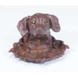 A cast iron inkwell shaped as a dogs head