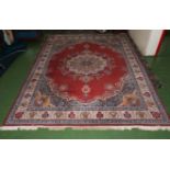 A large red ground wool rug 4m x 3m