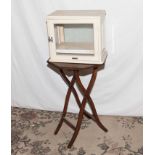 A small folding table and a vintage instrument cabinet