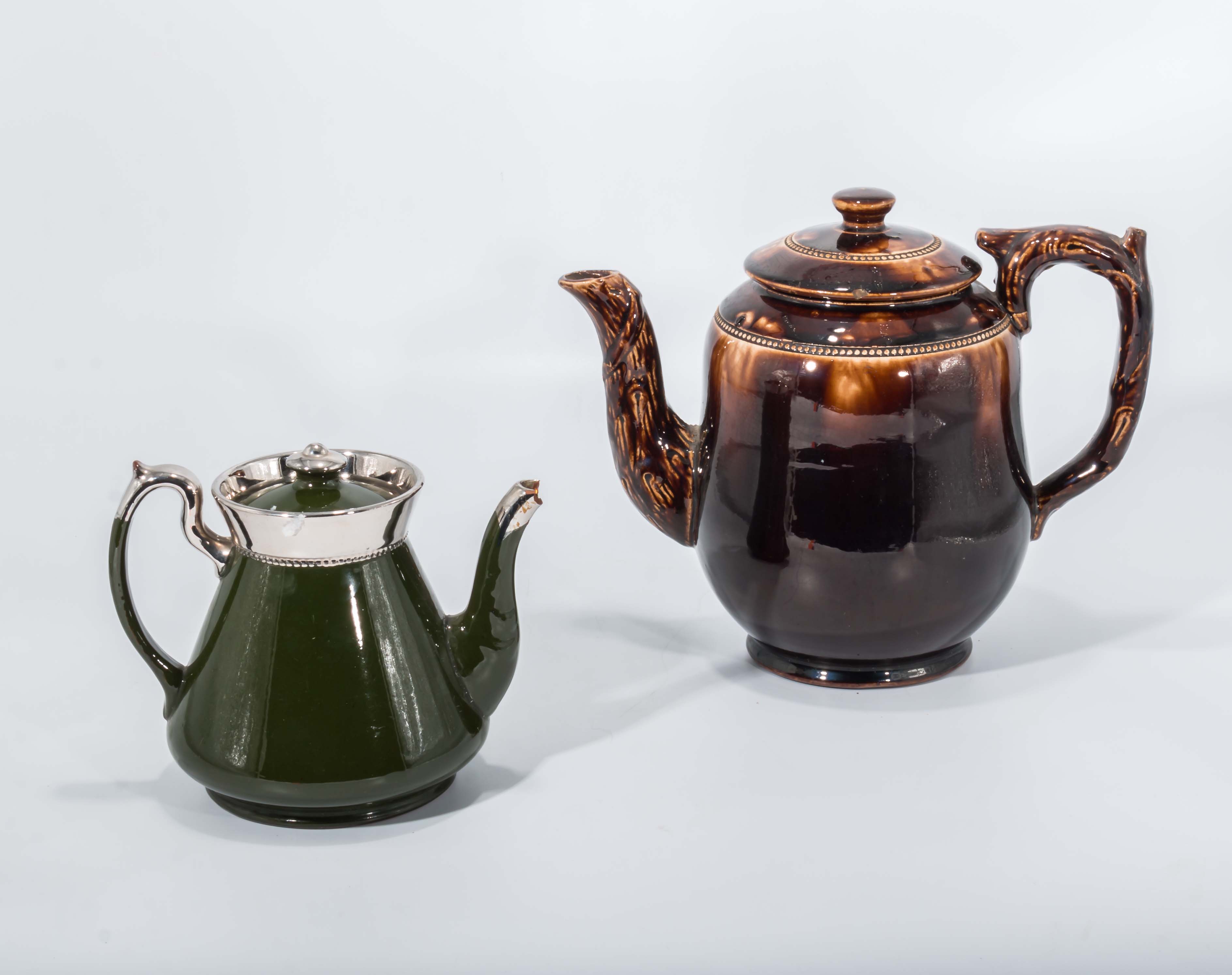 Large Victorian brown-glazed barge teapot together with a Green Art Deco lustre finish tea pot a/f