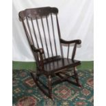 A spindle backed rocking chair